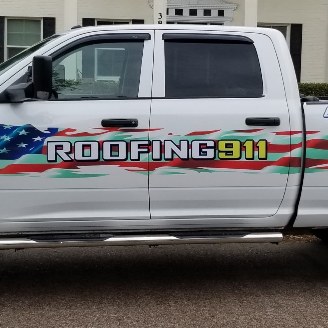 White Roofing 911 pickup truck with red, white and blue flag lettering